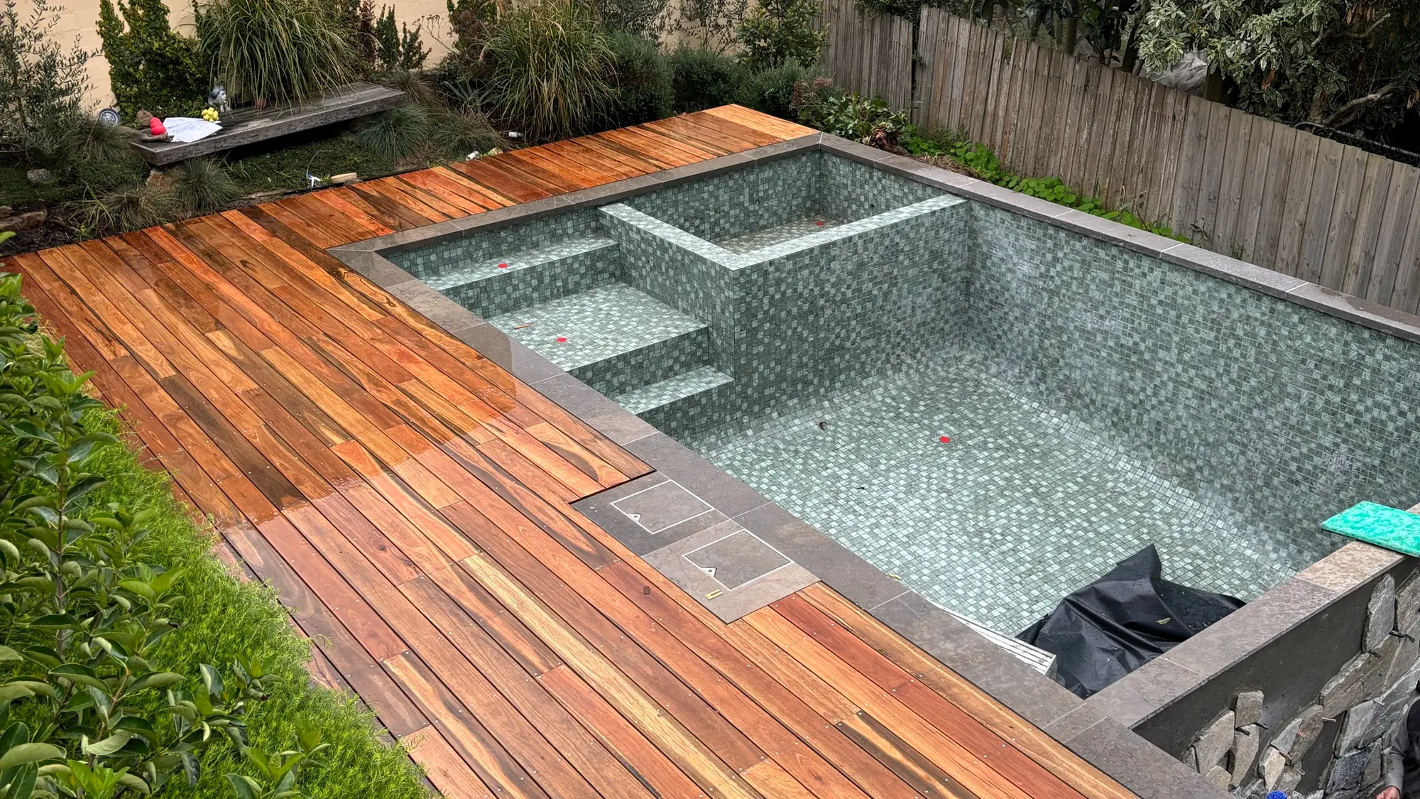 Merbau poolside deck with tiled surround built by BT Built in Ringwood